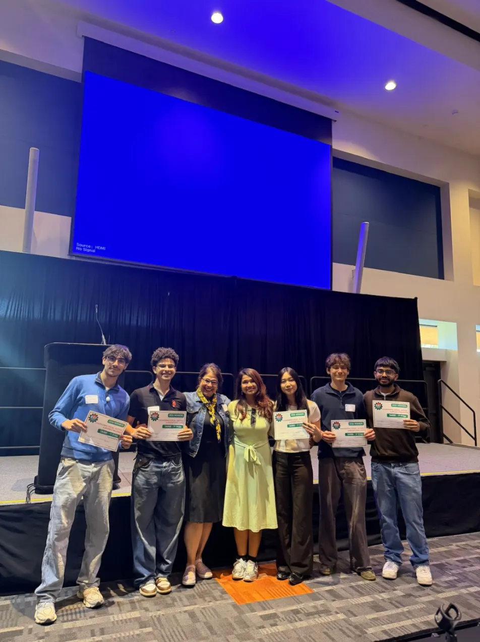 The Nested team with others on stage after the awards